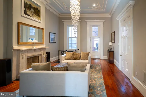 a living room with furniture and a chandelier