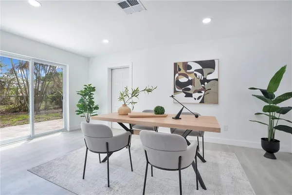 a view of a dining room with furniture window and wooden floor