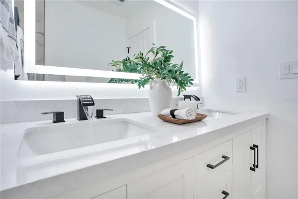 a bathroom with a sink a faucet and a mirror