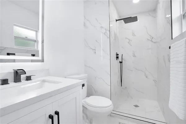 a bathroom with a sink toilet and shower