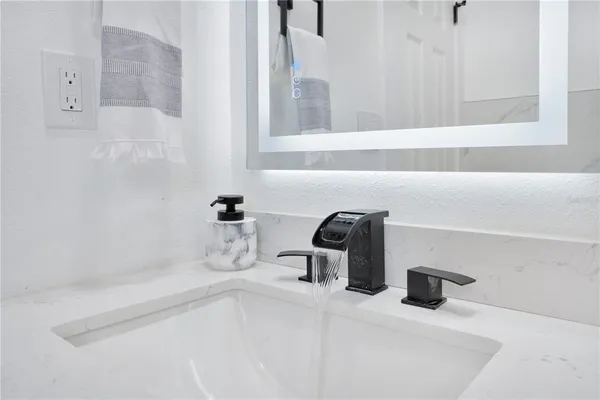 a bathroom with a sink and a mirror