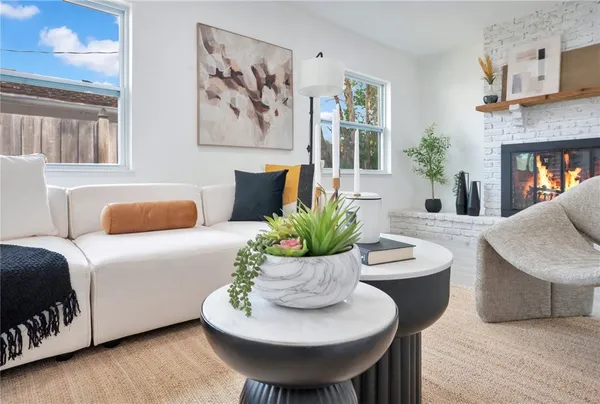 a living room with furniture and a potted plant