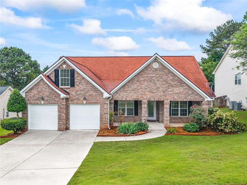 241 Red Bud Road Jefferson, GA 30549 - Photo 1 of 43 a front view of a house with a garden and plants