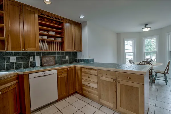 a kitchen with cabinets appliances and a sink