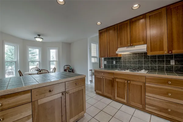 a kitchen with granite countertop cabinets and window