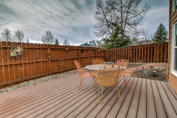 a view of balcony with wooden floor and outdoor seating