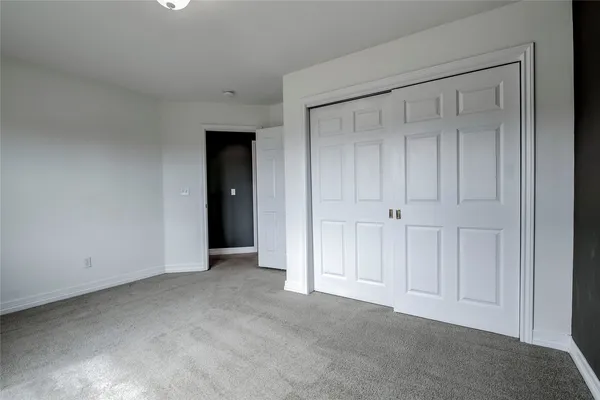 a view of an empty room with closet area