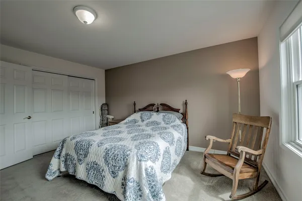 a bedroom with a bed and chair