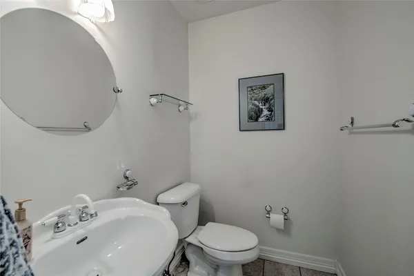 a white toilet sitting next to a bathroom sink