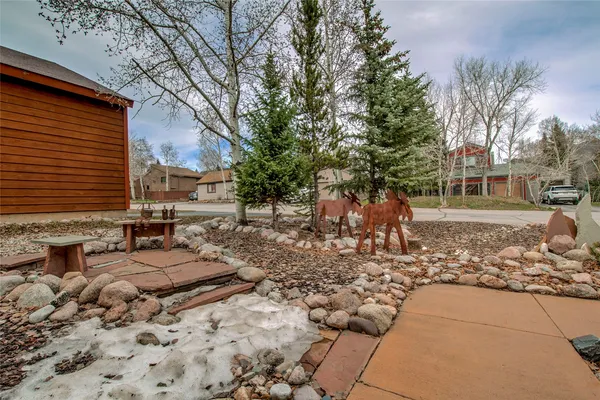 a backyard of a house with barbeque oven and outdoor seating
