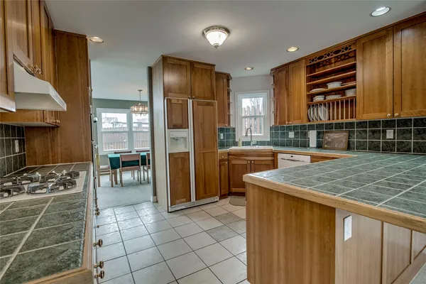 a kitchen with a sink a counter top space and cabinets