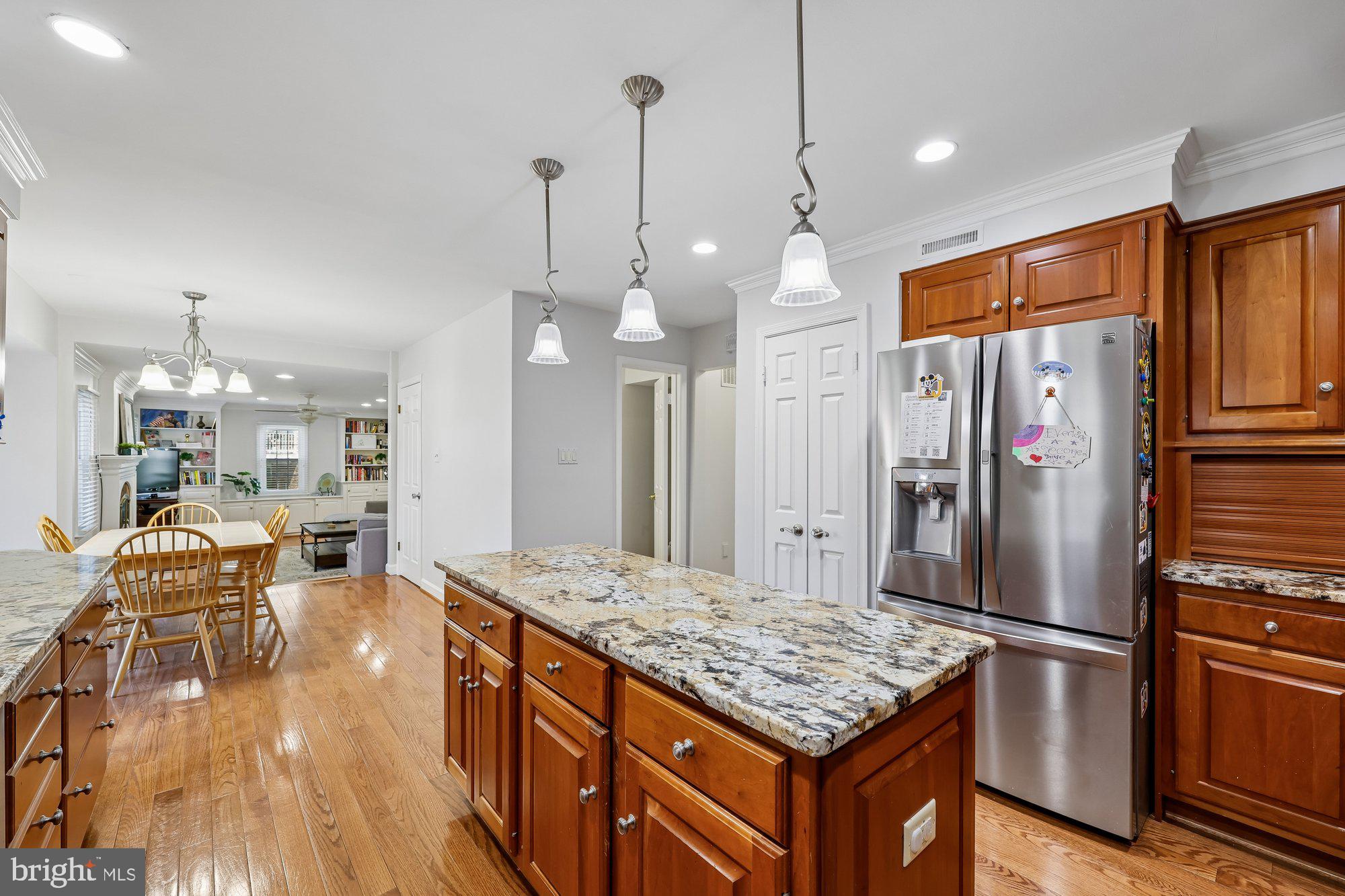 18 Kaywood Court Silver Spring, MD 20905 - Photo 23 of 71 a kitchen with stainless steel appliances granite countertop a refrigerator a stove and a sink with wooden floor