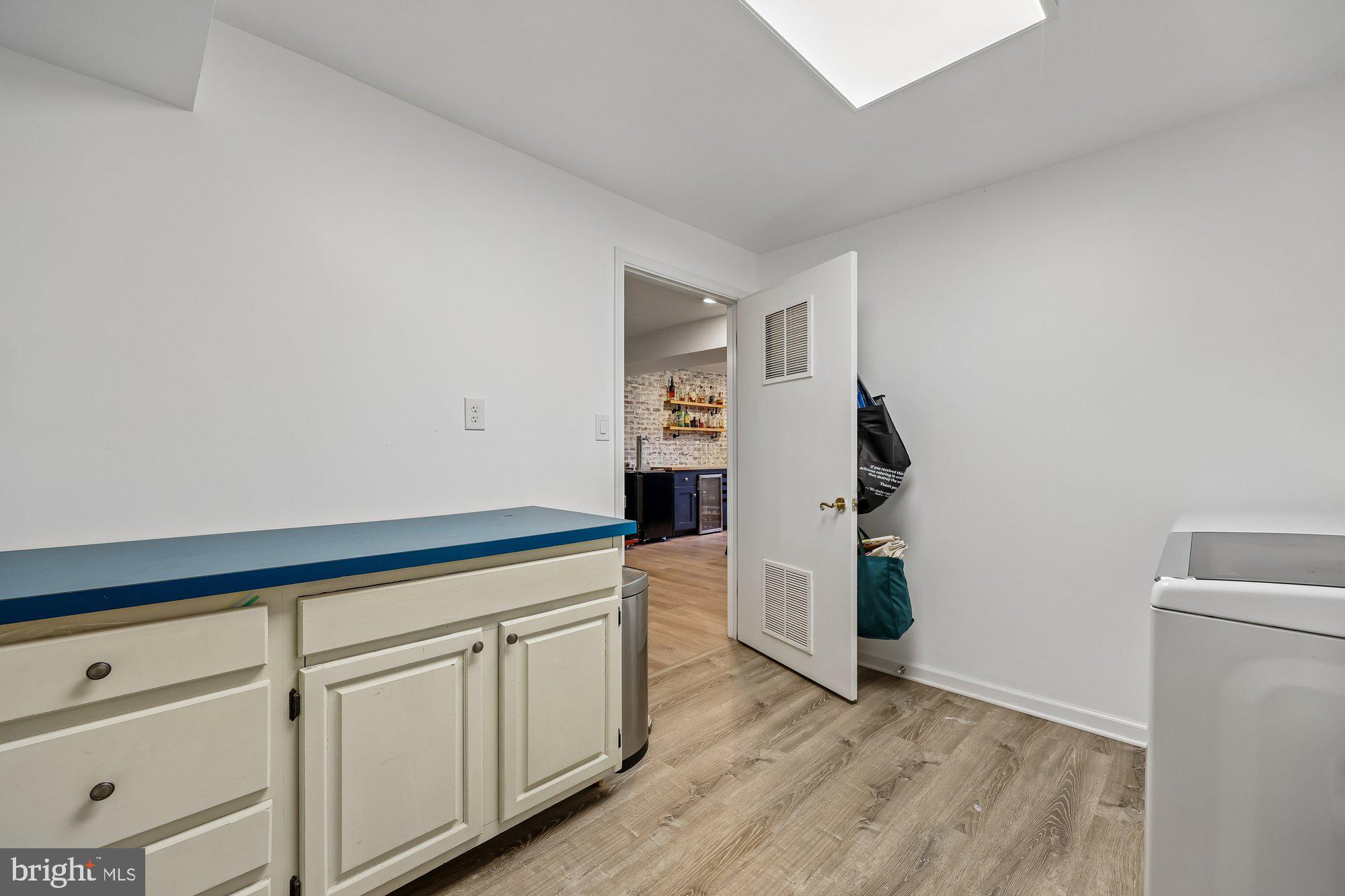18 Kaywood Court Silver Spring, MD 20905 - Photo 31 of 71 a hallway with white cabinets and wooden floor