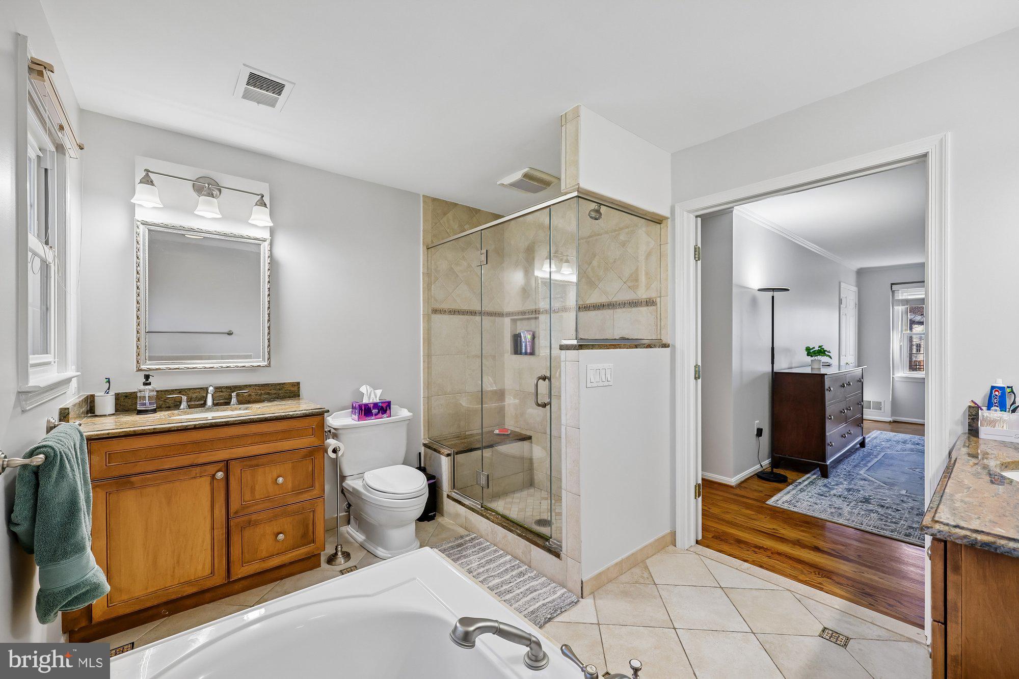 18 Kaywood Court Silver Spring, MD 20905 - Photo 42 of 71 a spacious bathroom with a granite countertop toilet a sink and a mirror