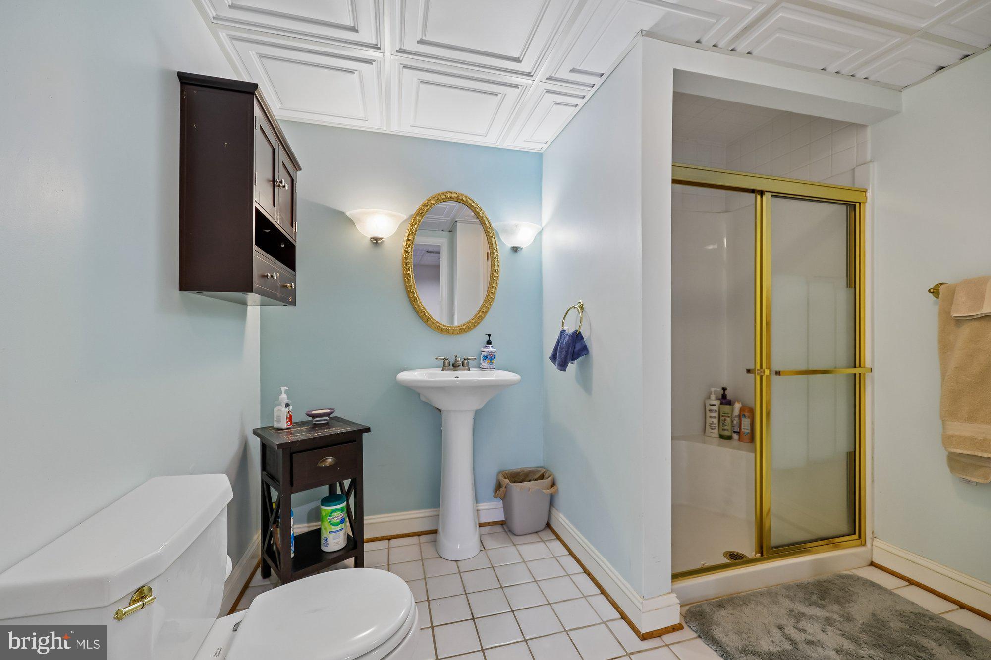 18 Kaywood Court Silver Spring, MD 20905 - Photo 69 of 71 a bathroom with a toilet a sink and mirror