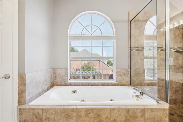 a bathroom with a tub and a window