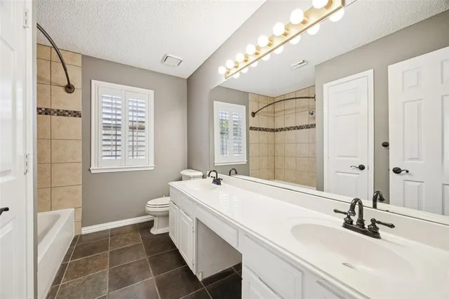 a bathroom with a double vanity sink mirror and double