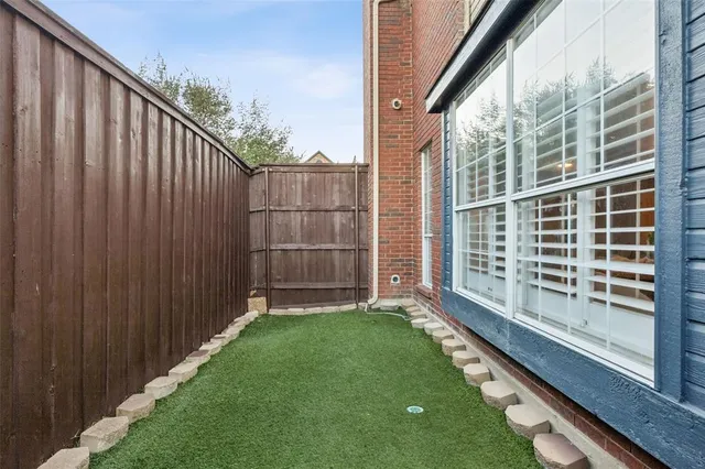 a view of a swimming pool with a patio and a yard