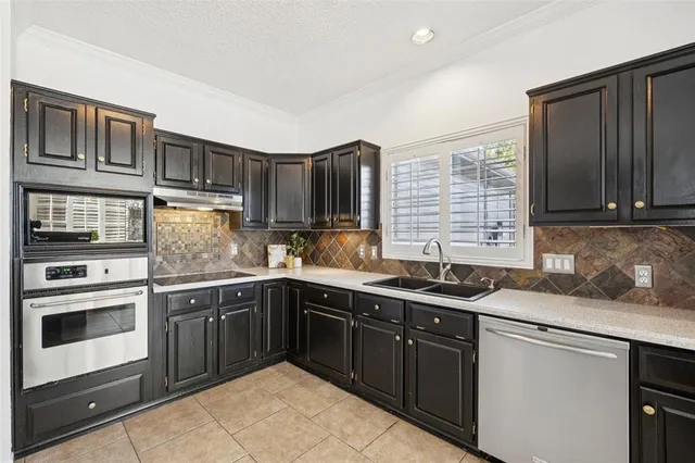 a kitchen with a sink stove and cabinets