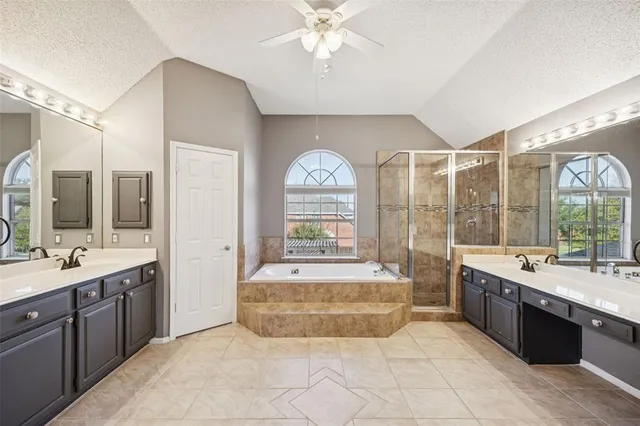 a large spacious bathroom with a large tub sink and mirror