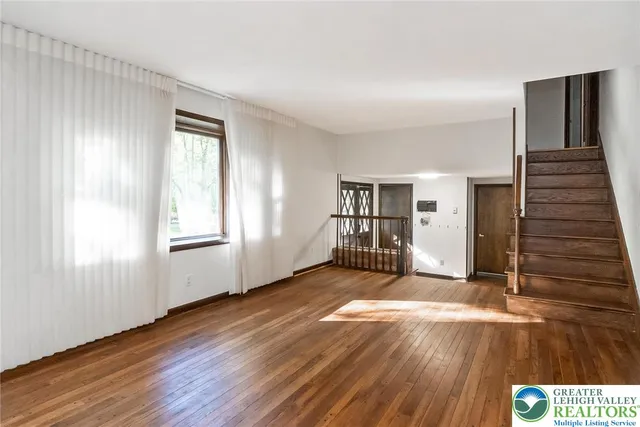 a view of a livingroom with an empty space and a fireplace