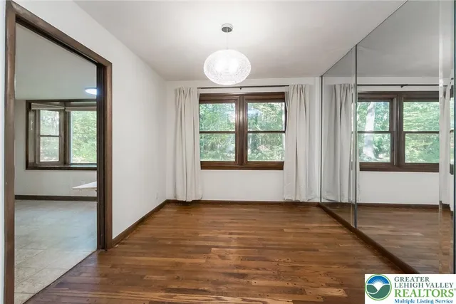 an empty room with a windows and closet