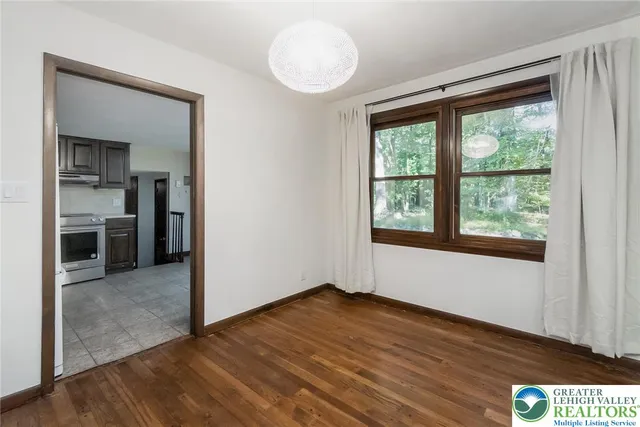 a bathroom with a bathtub a window and a shower