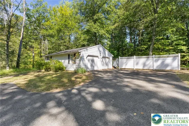 a view of an empty room with wooden floor and stairs