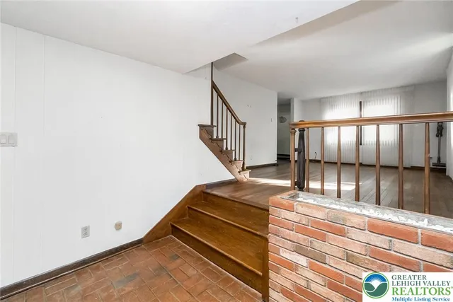 a view of an empty room with a fireplace and a window