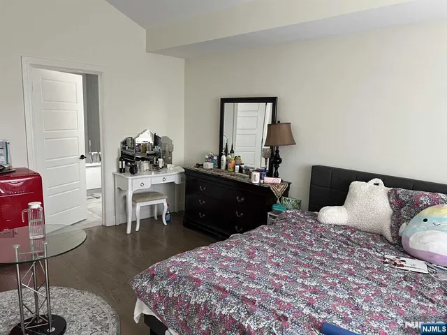 a bedroom with a bed and lamp