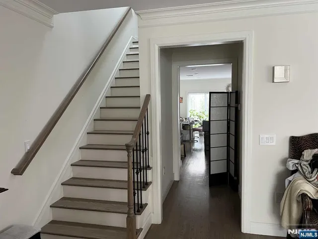 a view of a hallway with wooden floor and entryway