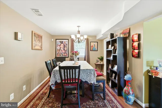 a view of a dining room with furniture and chandelier