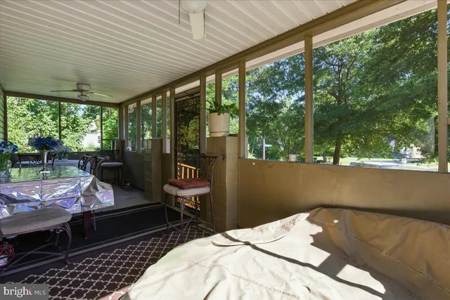 a view of a patio with table and chairs and potted plants