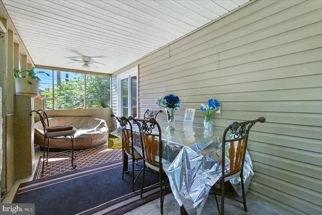 a view of a house with a yard and sitting area