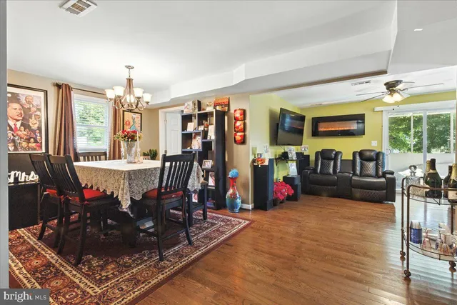 a living room with furniture a fireplace and wooden floor