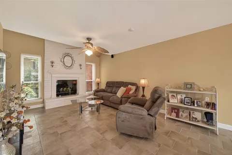 a view of a dining room with furniture a fireplace and wooden floor
