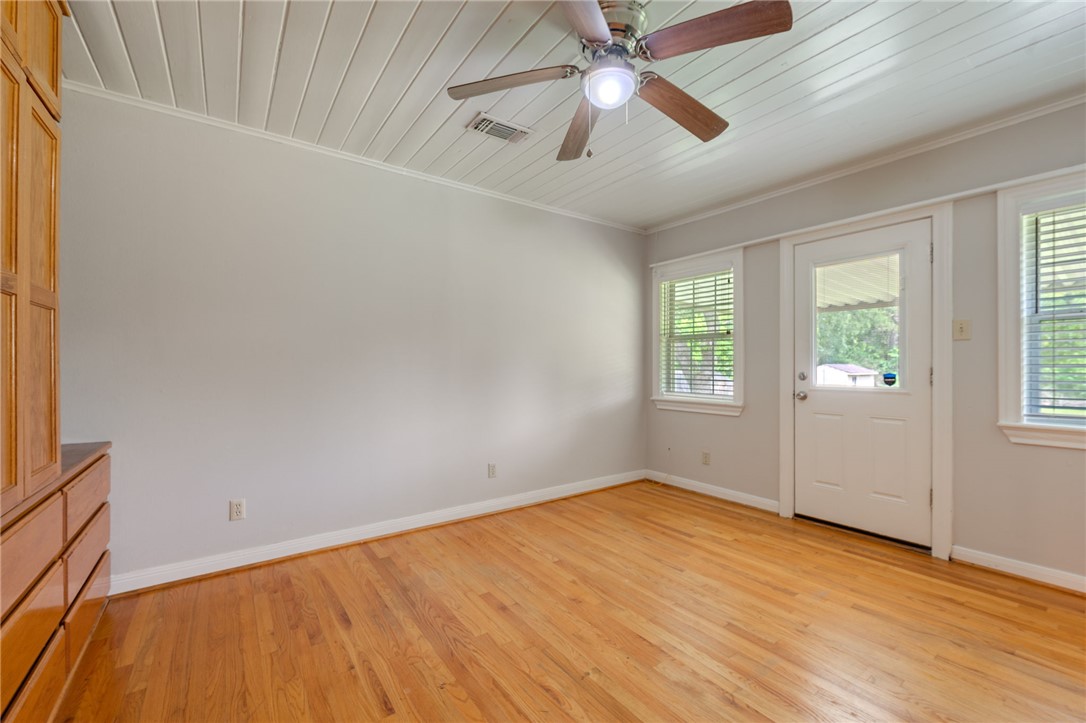 715 Inwood Drive Bryan, TX 77802 - Photo 6 of 34 wooden floor in an empty room with a window