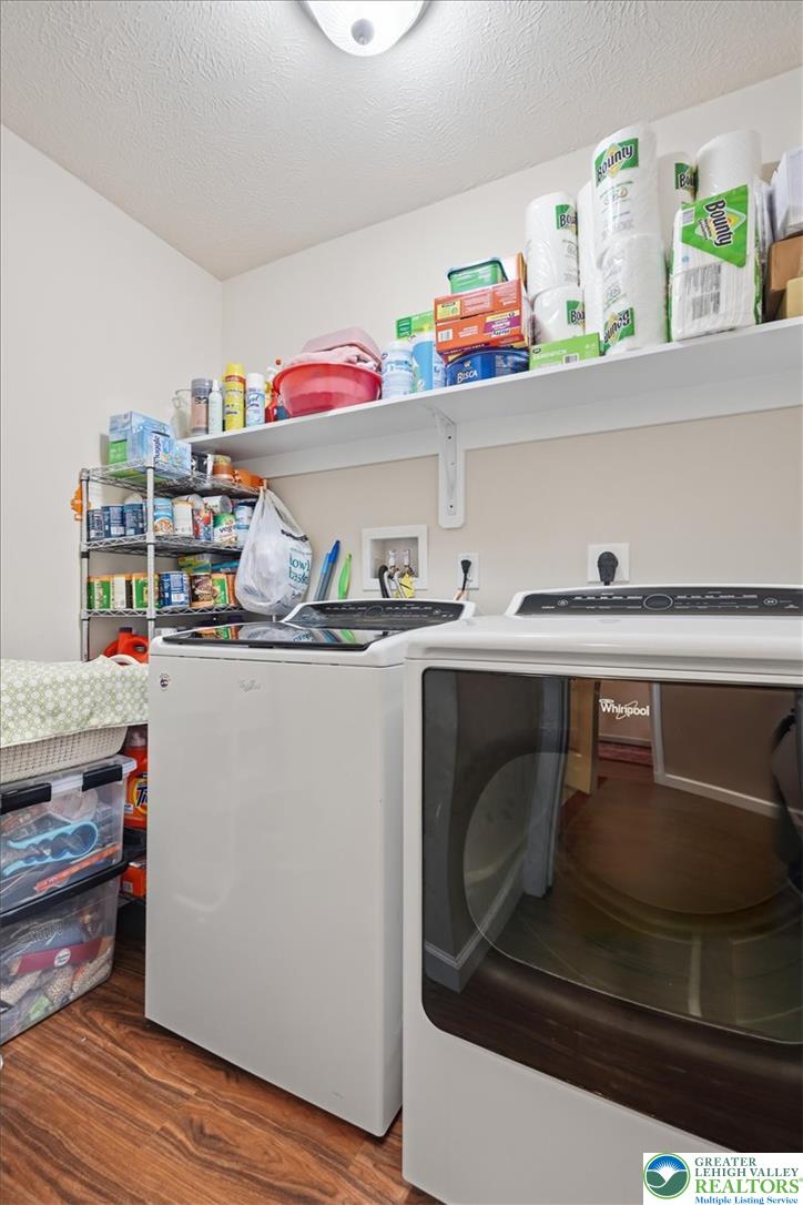 5032 Custard Road Stroudsburg, PA 18360 - Photo 33 of 80 Functional laundry space features overhead shelving and rich wood-toned flooring.