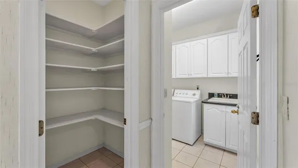 a spacious bedroom with a large bed and a chandelier