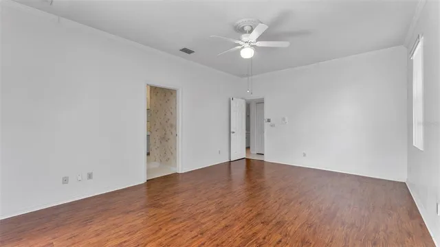 a room with pool table and windows