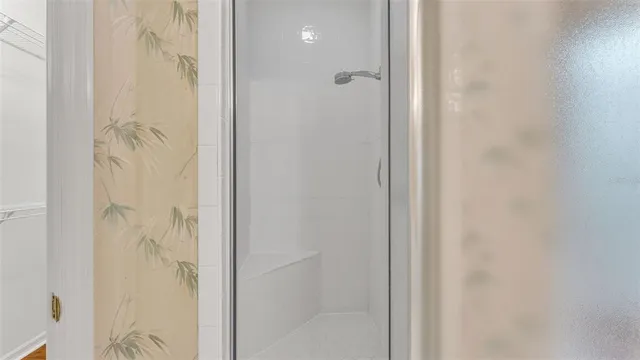 a bathroom with a granite countertop sink toilet a mirror a vanity and shower