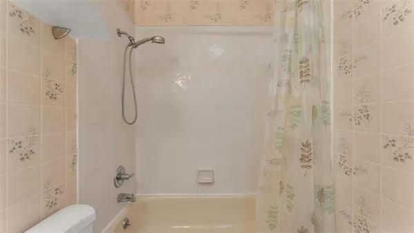 an aerial view of a house with a yard and lake view