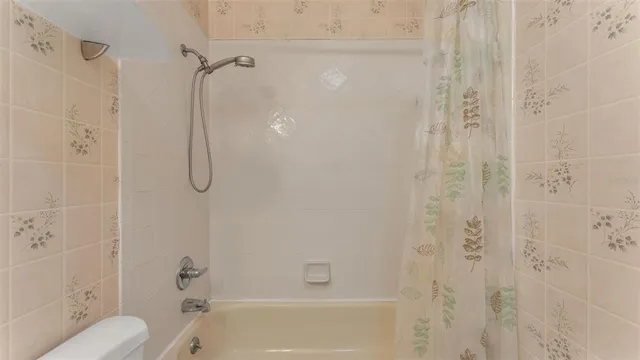 an aerial view of a house with a yard and lake view