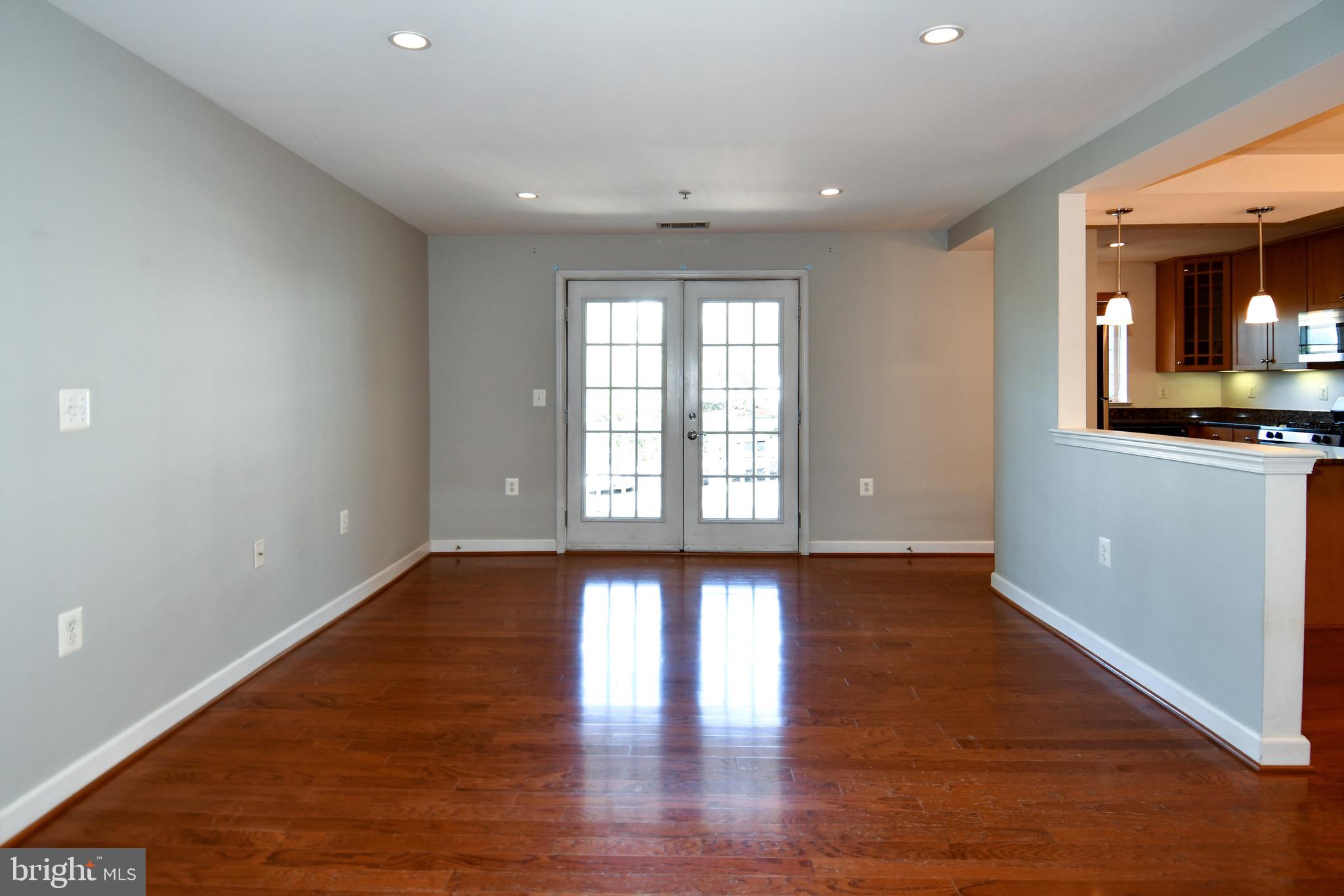 4127 South Four Mile Run Drive, Unit 304 Arlington, VA 22204 - Photo 14 of 44 a view of an empty room with window and wooden floor