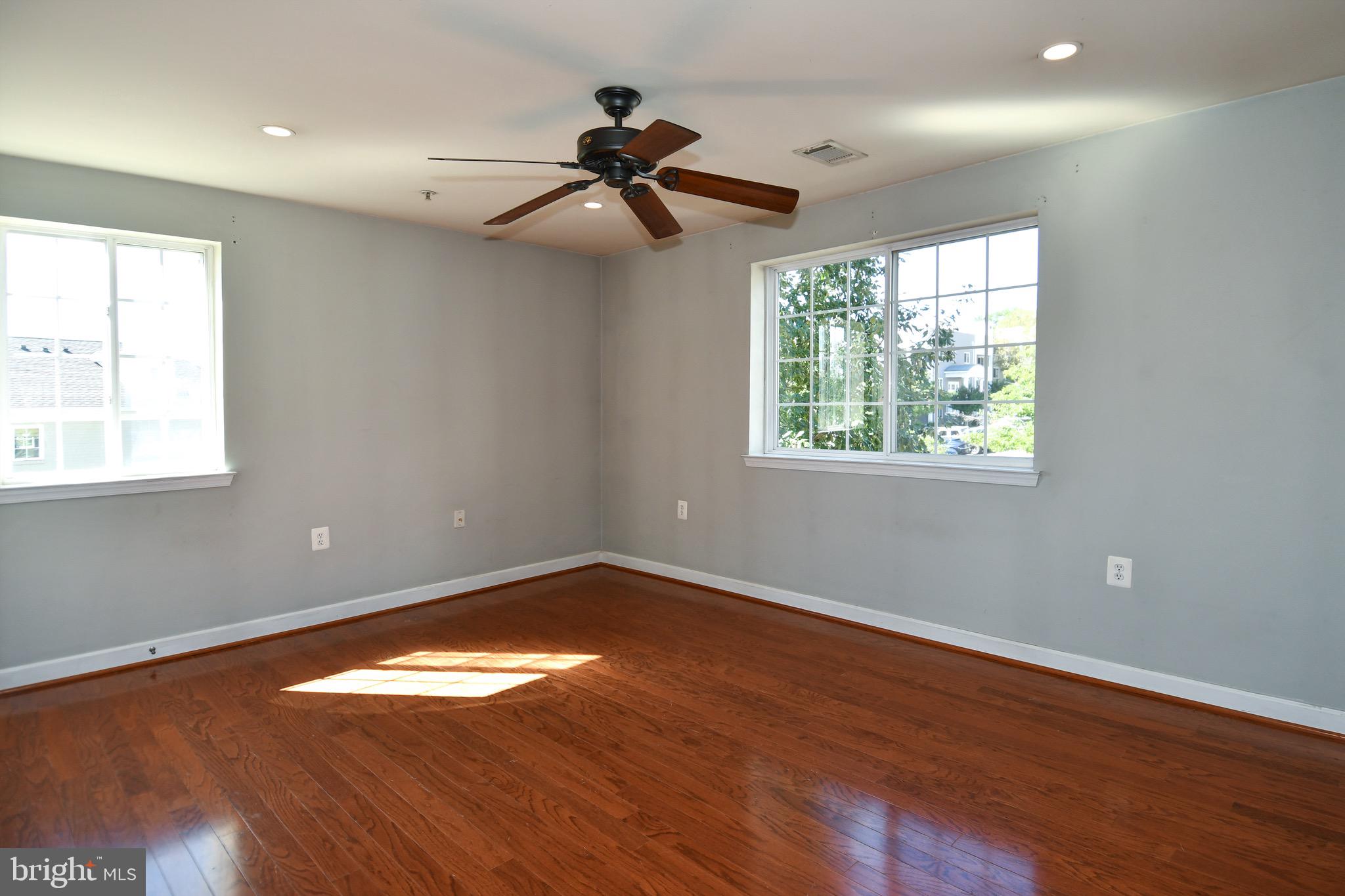 4127 South Four Mile Run Drive, Unit 304 Arlington, VA 22204 - Photo 21 of 44 a view of empty room with wooden floor and fan