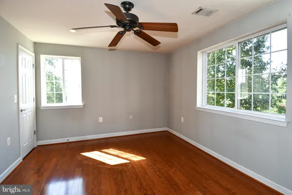 a view of a room with wooden floor and a window