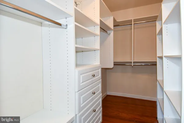 a view of walk in closet with empty racks