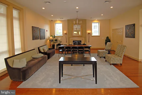a view of a workspace with furniture and wooden floor