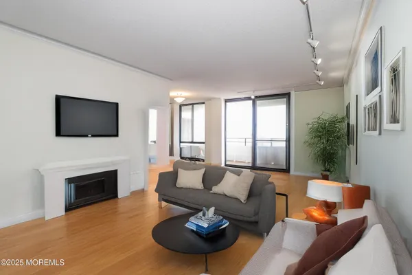 a living room with furniture a fireplace and a flat screen tv