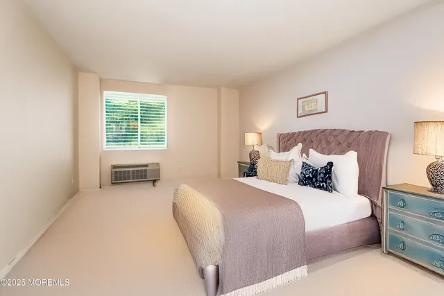 a spacious bedroom with a bed and a window